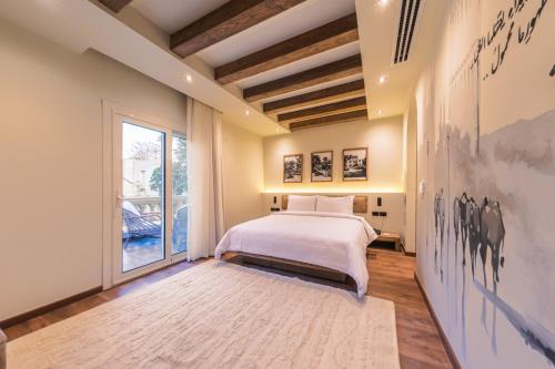 a bedroom with a bed and a large window at Sam's Story Boutique Hotel in Cairo