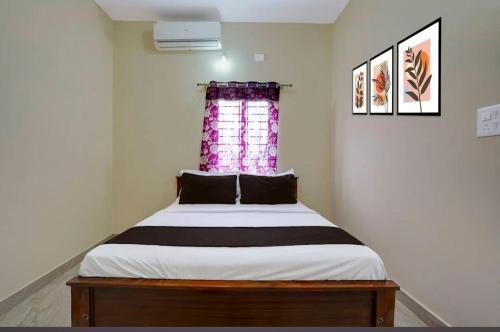 a bedroom with a large bed with a window at Kalpatharu Sprit Boarding and Lodging in Sivaganga