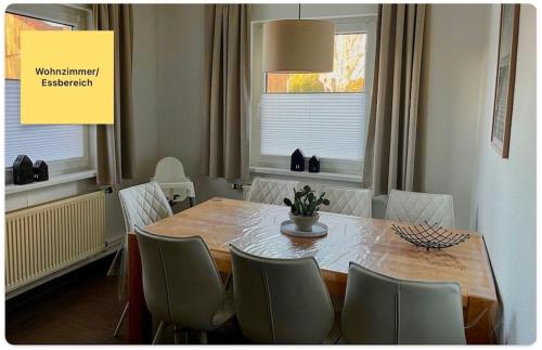 a dining room table with chairs around it with a yellow sign at Huus Negen in Neuharlingersiel