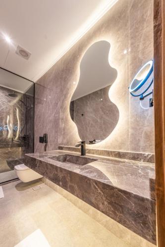 a bathroom with a sink and a mirror at Sam's Story Boutique Hotel in Cairo