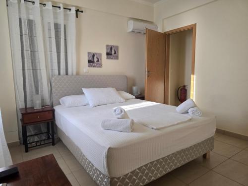 a bedroom with a bed with towels on it at Sunset View Studios in Agios Nikitas
