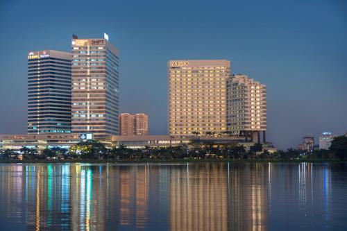 a city skyline with tall buildings and a body of water at Meliá Yangon in Yangon