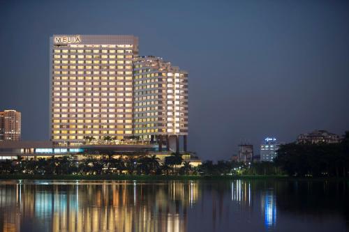 a large building with lights on in a city at night at Meliá Yangon in Yangon