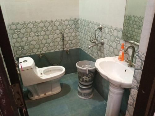 a bathroom with a toilet and a sink at Hotel Sasa Paradise in Lucknow