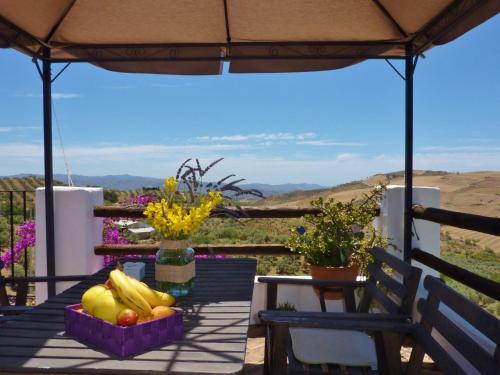 a table with fruits and vegetables in baskets on a patio at Belvilla by OYO Casa Coqui Juan Ram n in La Joya