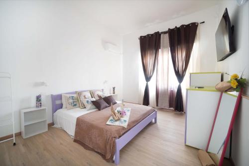 a white bedroom with a bed and a window at CHIARAGIULIA Camera Giulia Cabras in Càbras