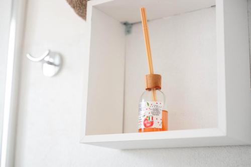 a bottle of sauce in a white cabinet at CHIARAGIULIA Camera Giulia Cabras in Càbras