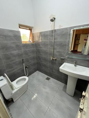 a bathroom with a toilet and a sink at Durrani Lodges - Islamabad G11 in Islamabad