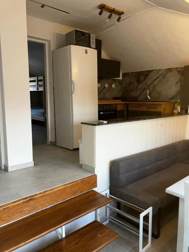 a kitchen with a couch and a refrigerator at Biser jezera in Gornja Šuma