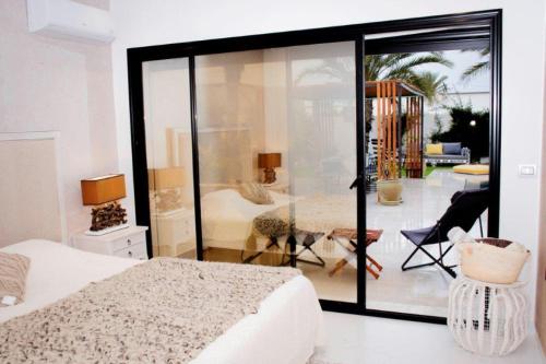 a bedroom with a bed and a view of a room at Villa el Kasbah in Midoun