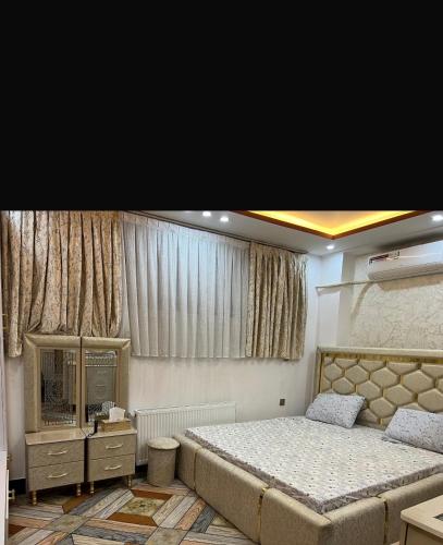 a bedroom with a large bed and a large window at Madina plaza 2 in Kabul