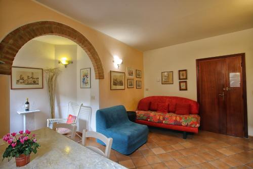 a living room with a couch and a chair at La Torre Nomipesciolini in San Gimignano