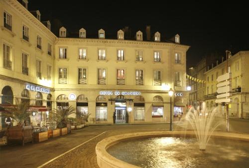 a building with a fountain in the middle of a street at Hotel De Gramont in Pau