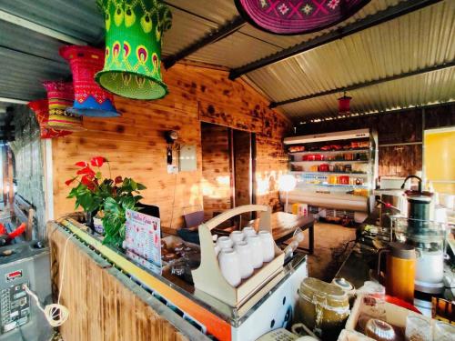 a kitchen with wooden walls and a counter in a kitchen at Bamboo Glamping Tà Xùa in Bắc Yên