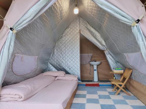 a bedroom with a bed in a tent at Bamboo Glamping Tà Xùa in Bắc Yên