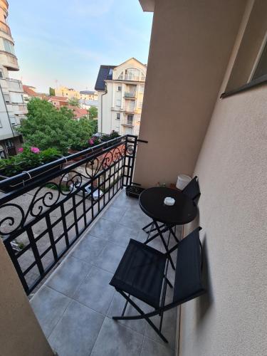 a balcony with a table and two chairs on it at Plavi Safir stan in Bijeljina