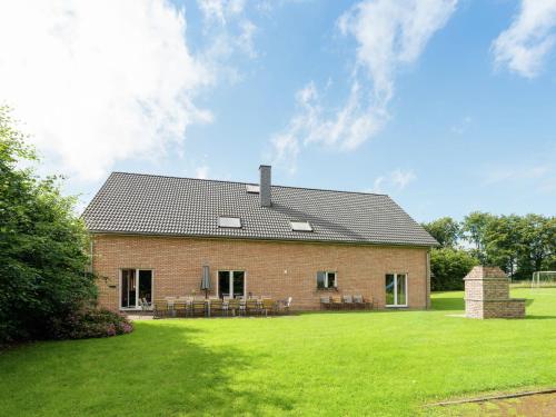 a brick house with a lawn in front of it at Holiday home in Waimes Robertville with sauna in Waimes