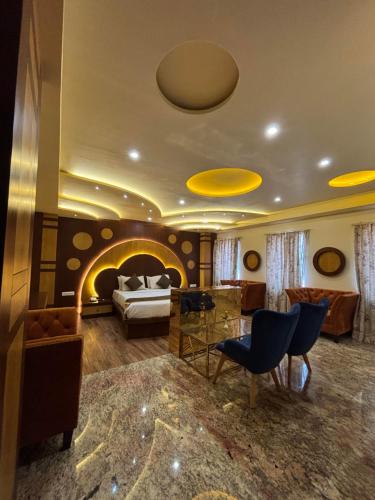 a large living room with a bed and a fireplace at Hotel White Rock in Bangalore