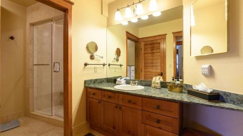 a bathroom with a sink and a shower and a mirror at Palmyra 3D by AvantStay Gorgeous Condo in Great Location in Telluride