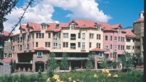 a large pink building with a red roof at Palmyra 3D by AvantStay Gorgeous Condo in Great Location in Telluride