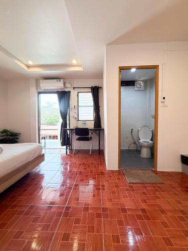 a bedroom with a bed and a bathroom with a toilet at Closca Hostel Koh Tao in Ko Tao
