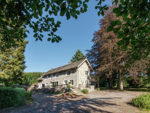 an old stone house on a dirt road at Holiday Home in Lavacherie with Terrace in Sainte-Ode