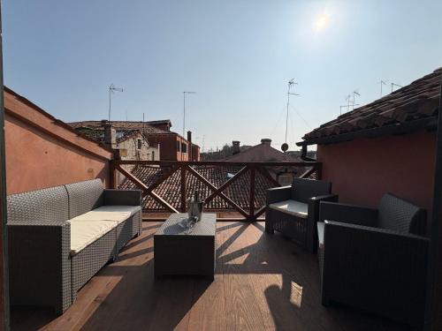a patio with couches and a table on a balcony at Ca' del Pope in Venice