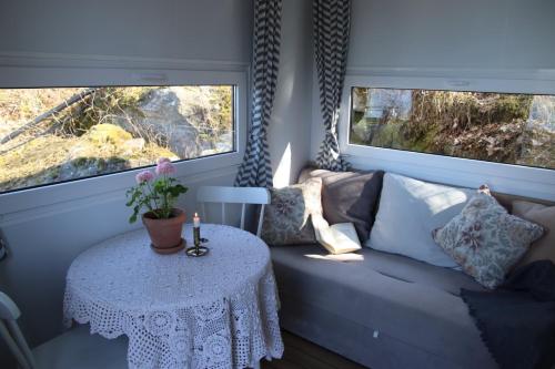 a living room with a couch and a table at Lillstugorna in Ljungskile