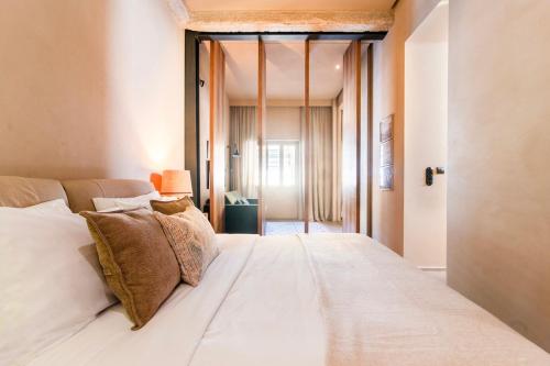 a large white bed in a room with a window at Architects Masterpiece Villa with Private Rooftop in Athens