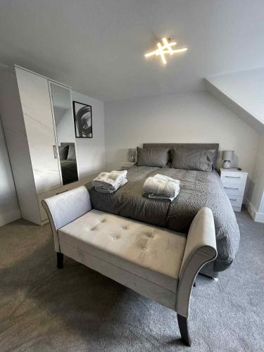 a bedroom with a bed and a cross on the ceiling at Home in Macduff in Macduff