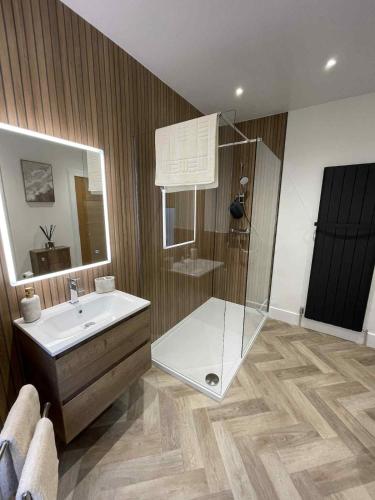 a bathroom with a glass shower and a sink at Home in Macduff in Macduff
