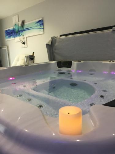 a bath tub with a candle in a bathroom at Appart&Spa in Toulouse