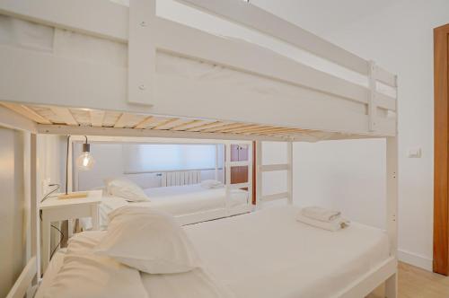 a white room with a bunk bed in it at Molí de Mar - Smart Hotel in Lloret de Mar