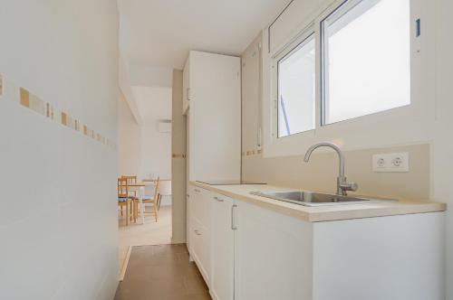 a kitchen with a sink and a window at Molí de Mar - Smart Hotel in Lloret de Mar