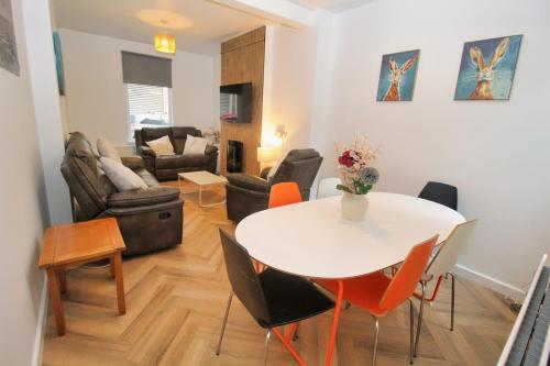a living room with a white table and chairs at Big Fish - Charles St South in Belfast