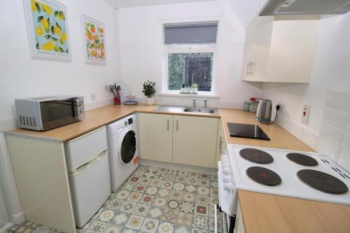 a kitchen with a sink and a stove top oven at Big Fish - Charles St South in Belfast