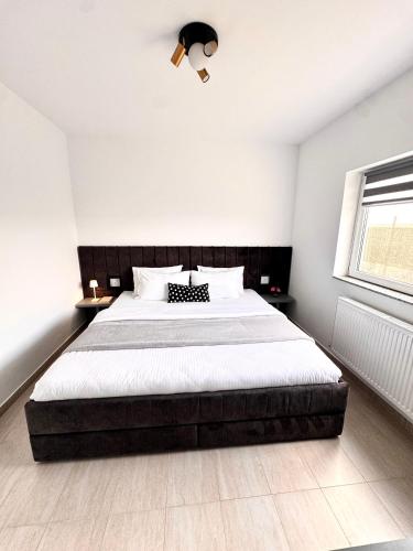 a bedroom with a large bed and a window at Studio in 2 Mai,Quiet,Spacious,Garden,Separate Bedroom - Donilads Properties - Home Everywhere in 2 Mai
