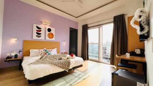 a bedroom with a bed and a large window at ZEN Medicity - Boutique Hotel Gurgaon in Gurgaon