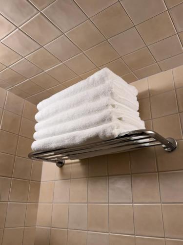 a stack of towels on a towel rack in a bathroom at yua sugar home in Daegu