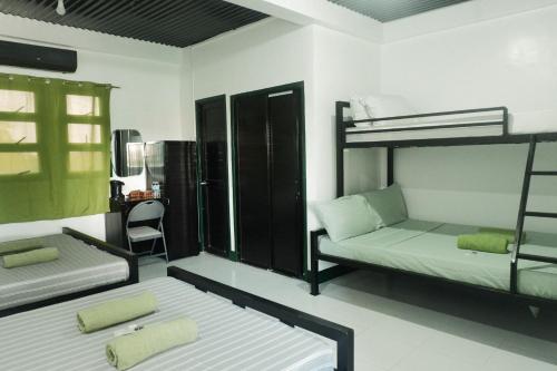 a room with two bunk beds and a chair at Tukad Guest House in Sampong