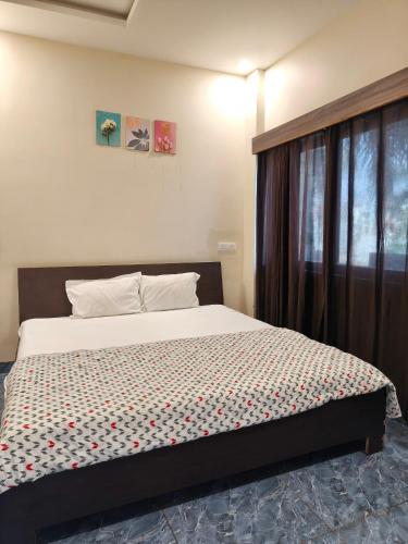 a bedroom with a bed in a room at Hotel Vriksh Stay in Godarpura