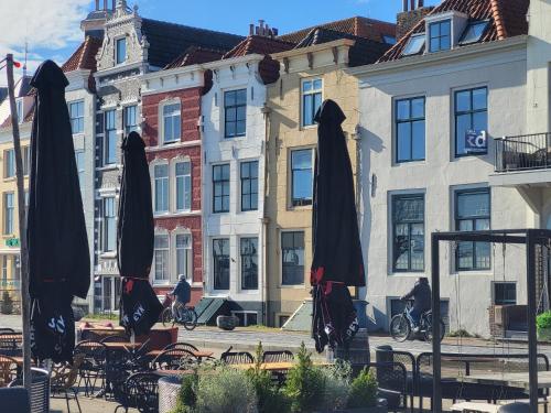 a group of umbrellas sitting in front of buildings at Rijksmonument Havenzicht, met zeezicht, ligging direct aan zee en centrum in Vlissingen