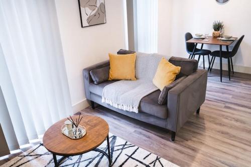 a living room with a couch and a table at Staycay - Modern 1-Bed Apartment in Manchester City Centre in Manchester
