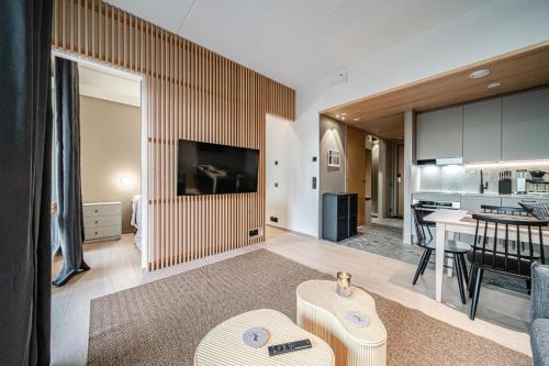a living room with a kitchen and a dining room at Gielas Joiku Chalet - Ski-in Ski-out - Mountain View - incl 2 ski passes in Kittilä