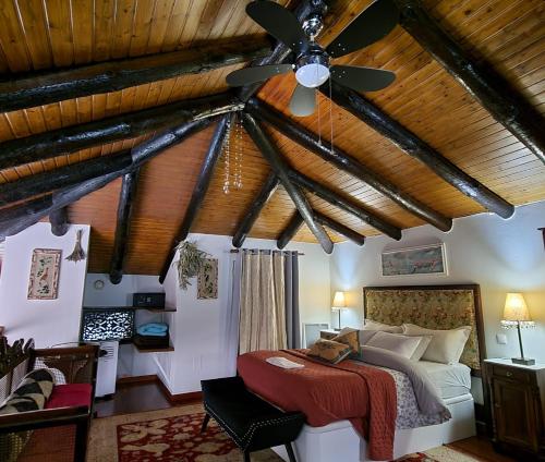 a bedroom with a bed and a ceiling fan at Boutique Chalet in Calheta in Arco da Calheta