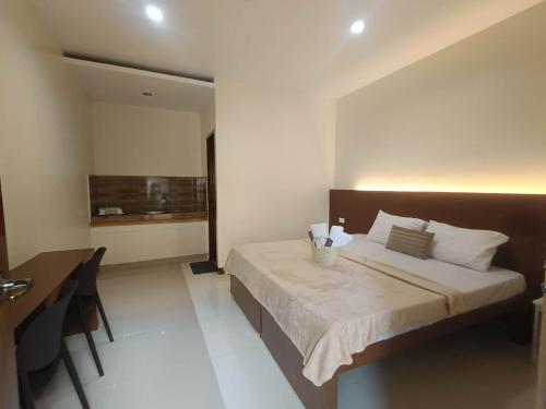 a bedroom with a bed and a desk in it at Little Haven at Lio in El Nido