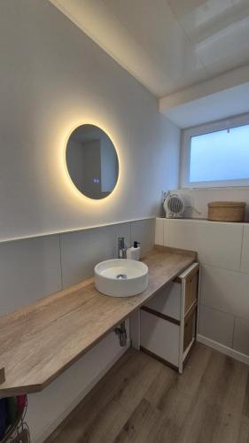 a white bathroom with a sink and a mirror at Studio Margny in Margny