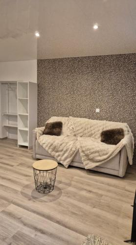 a bedroom with a bed with a blanket on it at Studio Margny in Margny