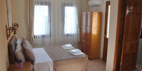 a bedroom with a bed with towels on it at The Dalyan's in Dalyan