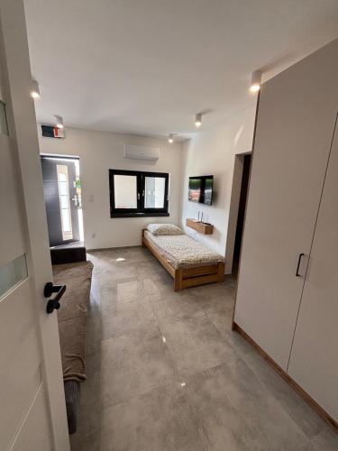 a bedroom with a bed and a sink in a room at Nocleg Szwed-Pol in Jastrowie